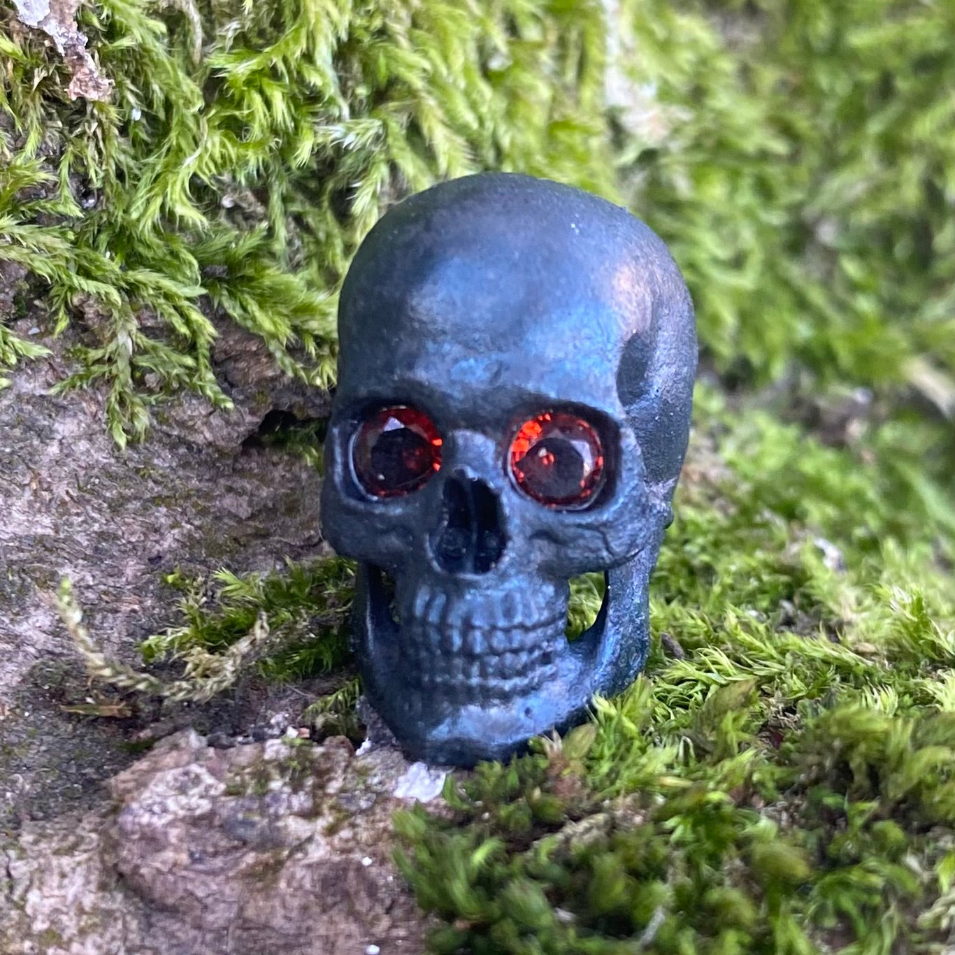 Realistic skull with garnet stone eyes limited bead