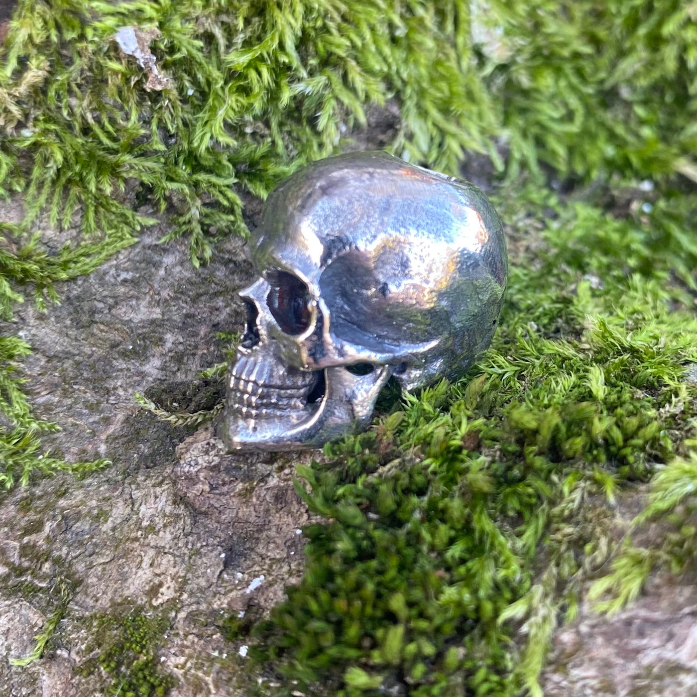 Realistic skull with garnet stone eyes limited bead